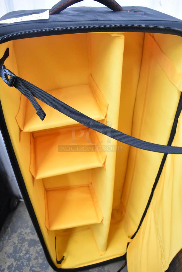 Kata Case with padded orange interior, adjustable shelves, black exterior, zipper, and handle. Ideal for secure equipment storage.