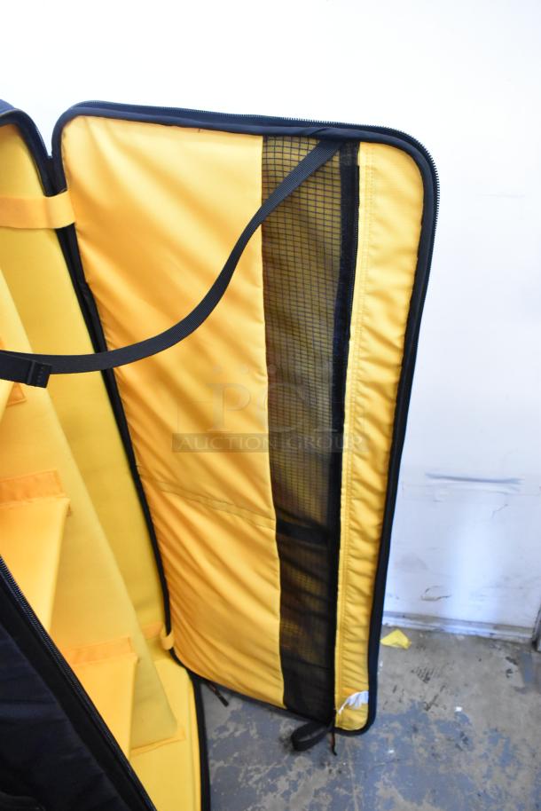 Yellow Kata case with interior compartments, mesh pocket, and zipper. Well-constructed for gear protection. Good condition.