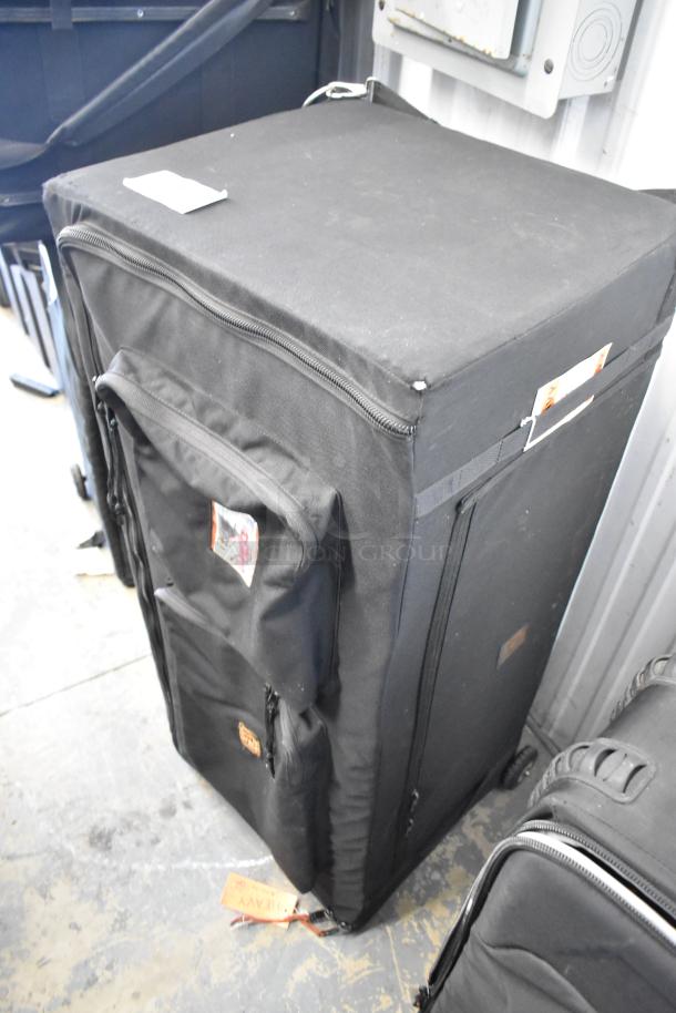 Black Porta Brace case with zippered compartments and visible tags. Sturdy, large size, suitable for heavy-duty equipment storage.