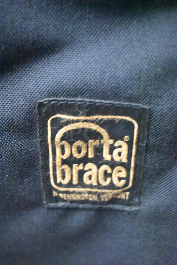 Porta Brace case label in gold text on black fabric. High-quality craftsmanship. Made in Bennington, Vermont.