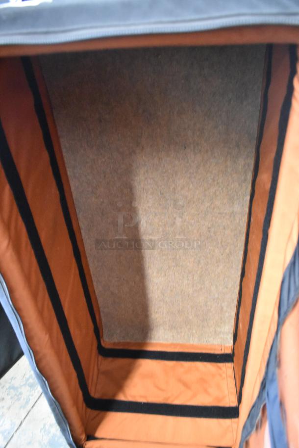 Porta Brace case interior, showing orange padding and black lining. Appears spacious and sturdy, ideal for equipment.