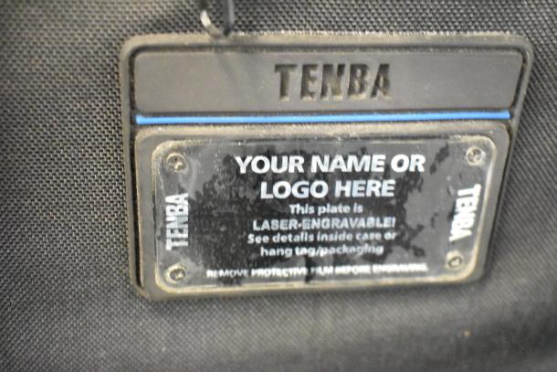 Three camera bags including Lowepro, Tenba, and Porta Brace. Features laser-engraved Tenba tag. Size: 16x10x25 inches.