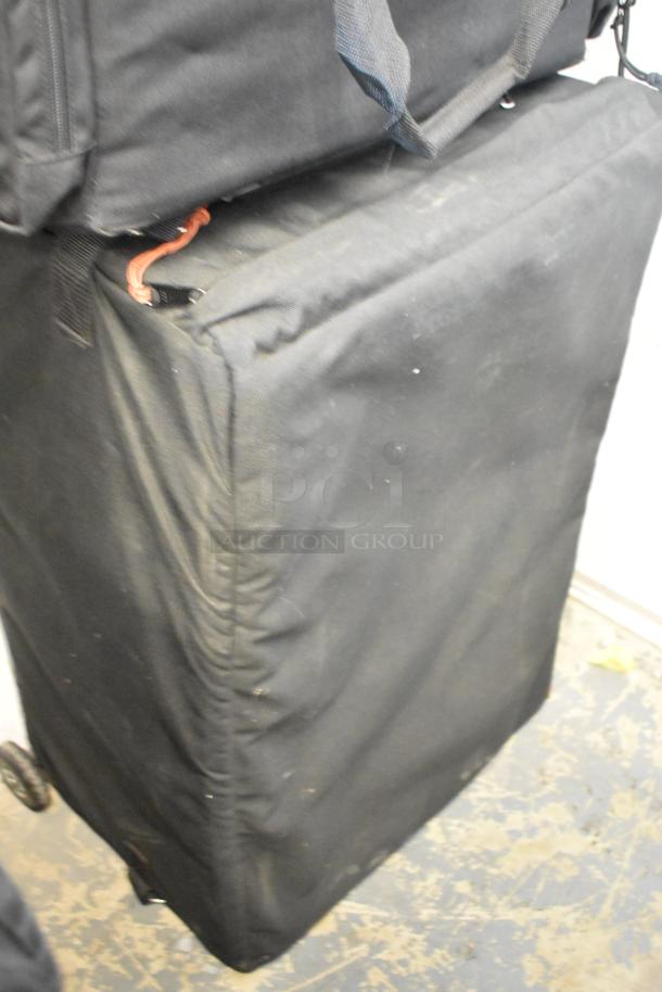 Three black bags from Lowepro, Tenba, and Porta Brace. Dimensions 16x10x25. In used condition with visible handles.
