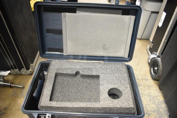 Open hard case with custom foam inserts, in excellent condition, designed for secure equipment storage and transport.