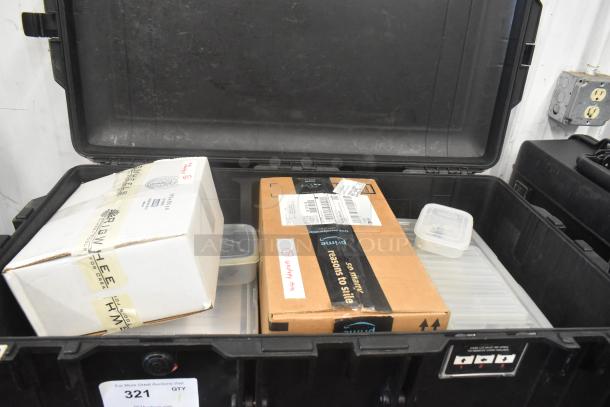 Pelican hard case containing boxes, adapters, Zip Linq, and poly containers. Items appear in good condition.
