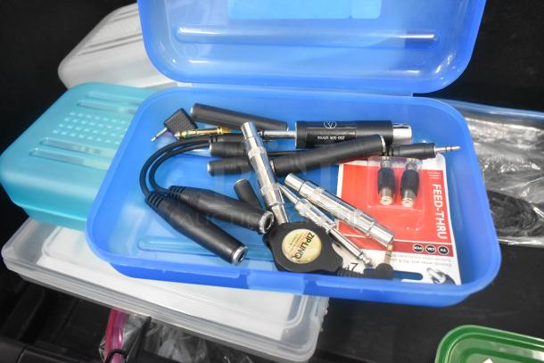 Pelican hard case with electronic adapters, Zip Linq cord, and poly containers. Various connectors and feed-thru package visible.