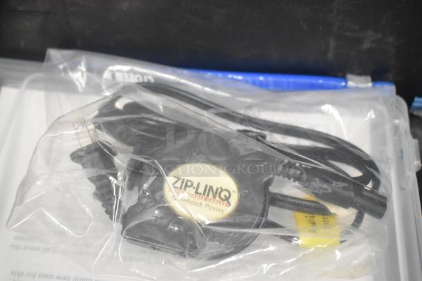 Pelican hard case with contents including adapters, Zip Linq retractable cable, and poly containers.