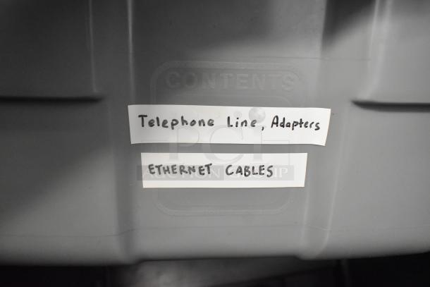 Stanley hard case labeled "Contents," includes telephone line adapters, Ethernet cables. Durable storage with essential hardware.