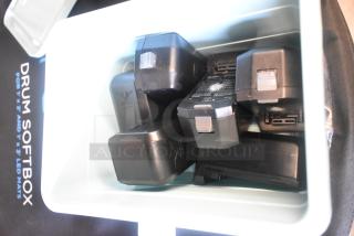 Poly bin containing several Movi Pro batteries, used condition, visible labels with specs and charge indicators.