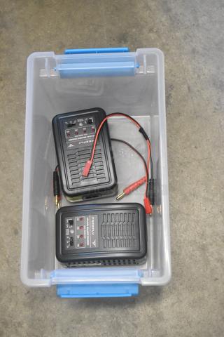 Poly bin containing two Firefly lithium balance chargers with cables and connectors. Bin has blue handles.