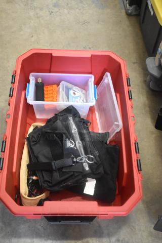 Lot of various items in a red Husky poly bin, including a black bag, plastic containers with tools, and miscellaneous gear.