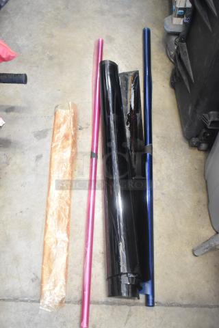 Four rolls of lighting filter film in various colors, including pink and blue, in good condition on a concrete floor.