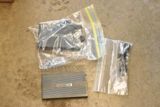 Lot of SmallHD power bricks in poly bags, good condition, with cables. Includes original branding on sleek design.