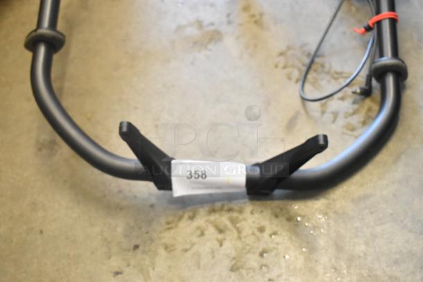 Sturdy black metal frame with curved ends, condition unknown. Tag marked "358" attached to the frame.
