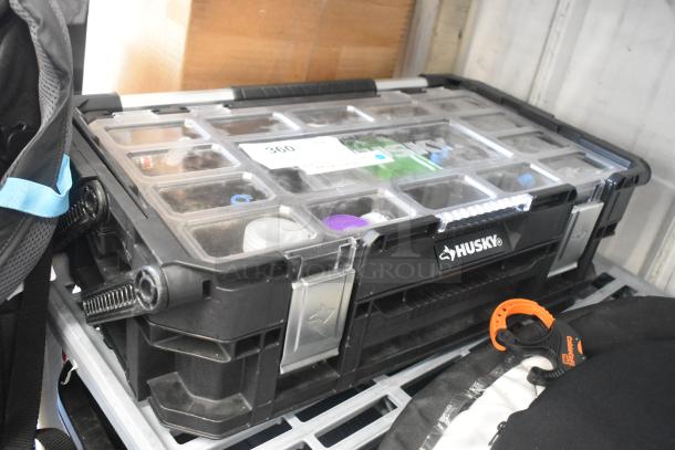 Husky poly bin with hardware, transparent lid, organized compartments, sturdy black and silver design, visible contents inside.
