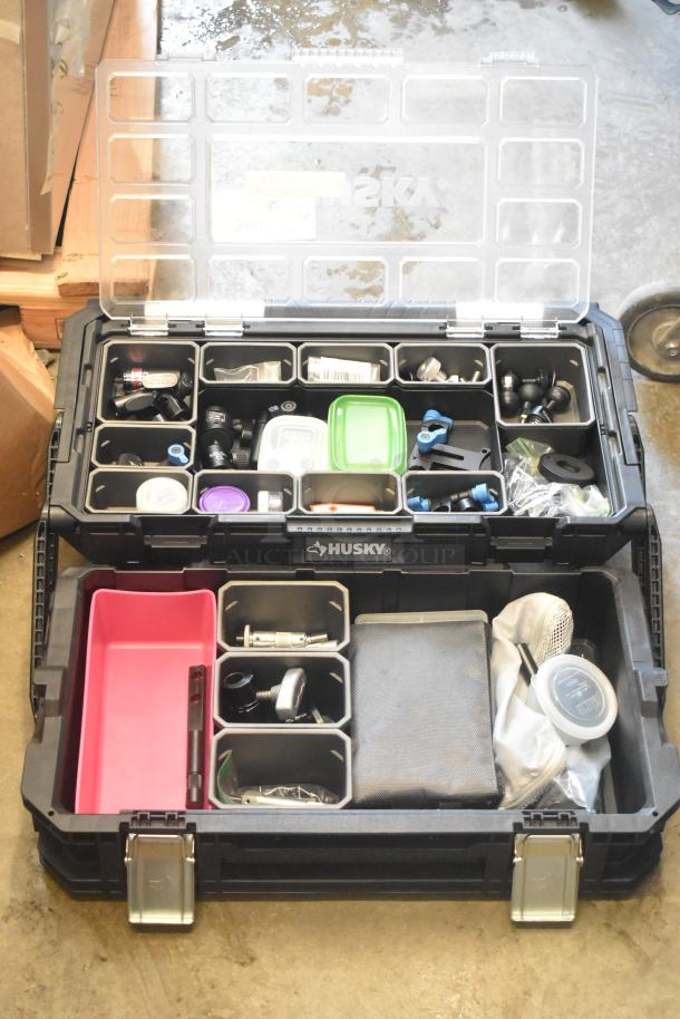 Husky poly bin with assorted hardware, including connectors, fasteners, and fittings. Bin has compartmental storage.