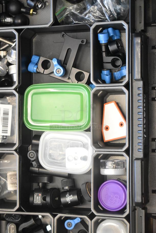 Husky poly bin filled with assorted hardware, including connectors, knobs, and small containers. Labels visible on some contents.