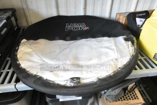 Luma Pop Unit in black case on shelf, visible brand logo. Includes label with auction lot number 362. New condition.
