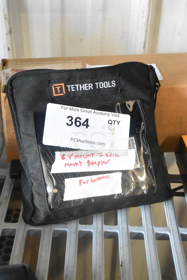 Tether Tools V Mount to Gold Mount Adapter, includes black carrying case with clear front pocket, labeled for batteries.