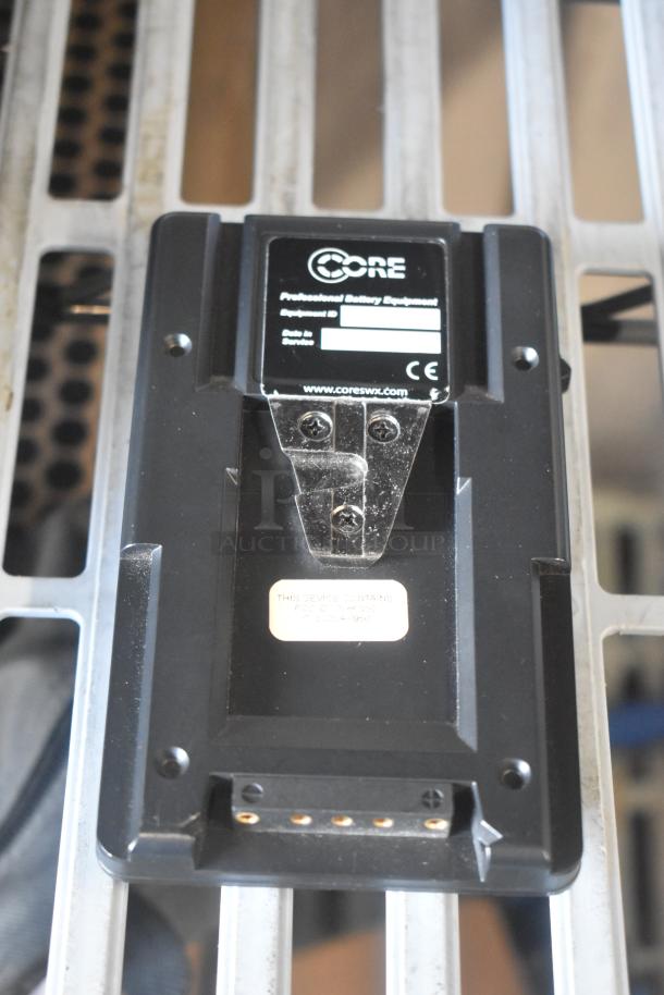 V Mount to Gold Mount Adapter by Core SWX, professional battery equipment, CE mark, appears in used condition.