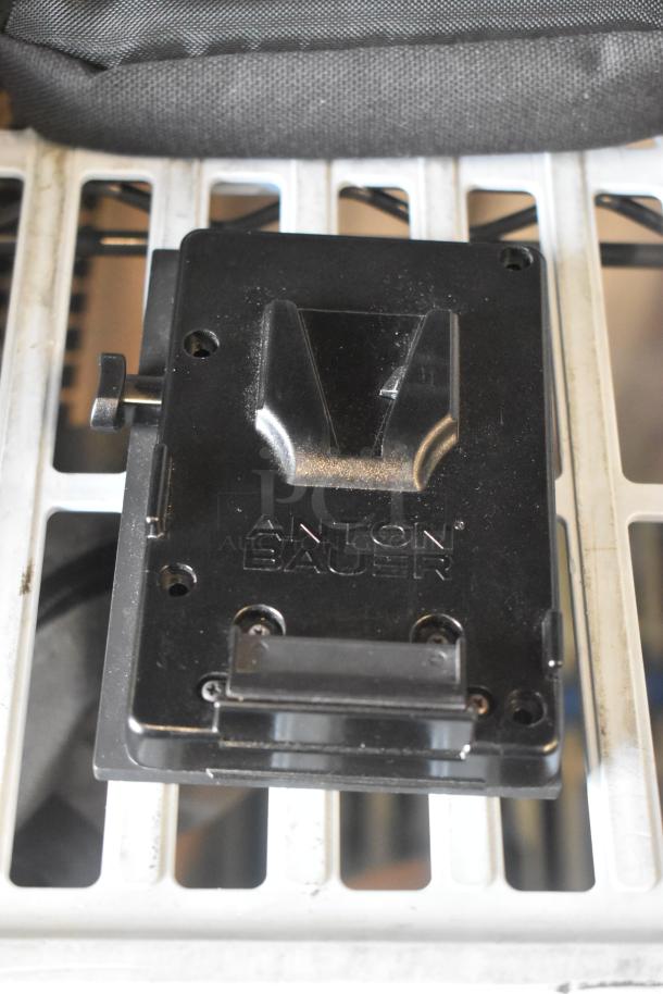 Anton Bauer Mount in black, showing brand logo. Appears in good condition. Designed for secure battery attachment.