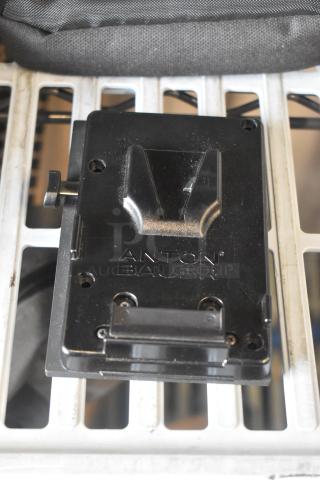 Anton Bauer Mount in black, showing brand logo. Appears in good condition. Designed for secure battery attachment.