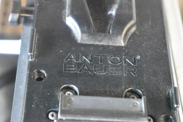 Anton Bauer Mount, black, embossed brand logo, used condition, mounting holes visible. Ideal for camera equipment setup.