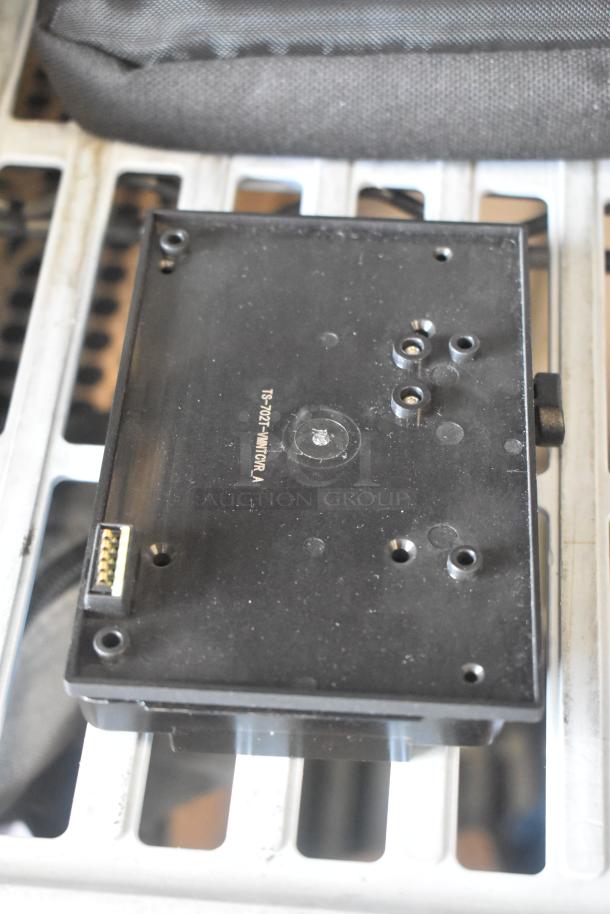 Anton Bauer Mount in black, featuring multiple connection points. Visible marking "TS-0121". Good condition.