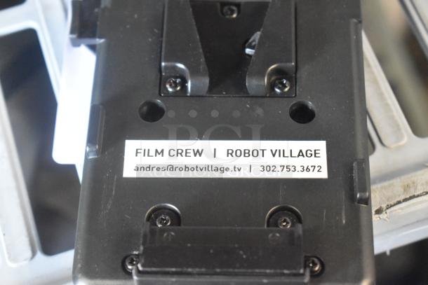 Tether Tools V Mount in good condition. Features an attached label: "Film Crew | Robot Village." Contact info: andres@robotvillage.tv, 302.753.3672.