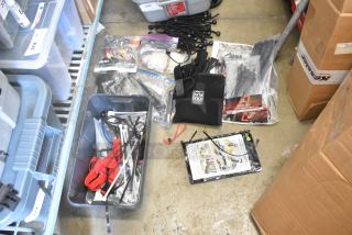 Lot of items including Porta Brace fasteners, poly bins, tie-down straps, and cables in various conditions.