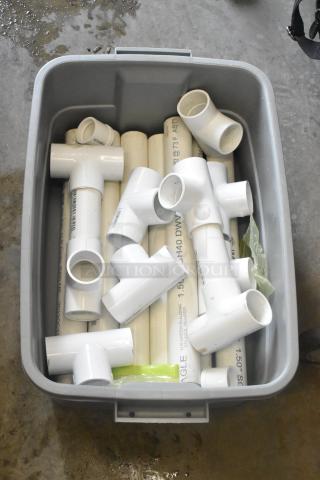 Bin of PVC pipe fittings includes T-joints, elbows, and straight pipes. Items are white with visible size markings. Good condition.