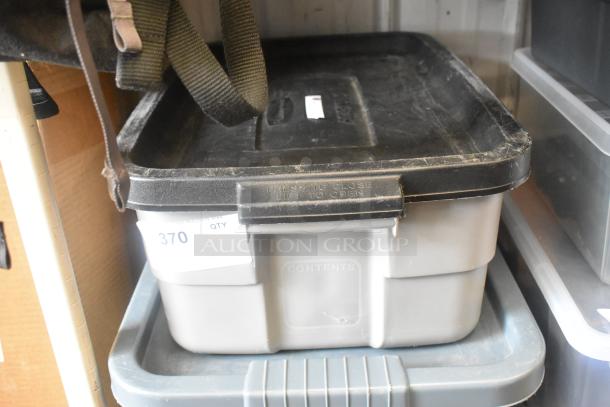 Poly bin containing assorted PVC pipe fittings, black lid with "Press to Close" text, minor wear visible, inventory tag "370".