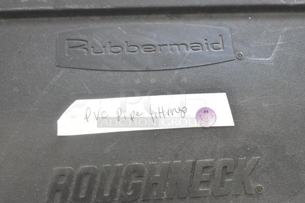 Rubbermaid Roughneck poly bin with handwritten label "PVC Pipe Fittings" featuring a smiley face sticker.