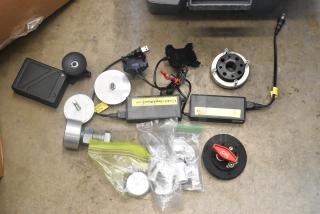 Lot of various hardware items in poly bin; includes adapters, power cords, control knobs, and metal components. Mixed condition.
