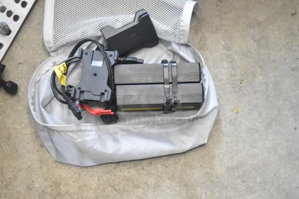 Lot of various hardware items in poly bin, includes cables, black components, and Velcro straps. Some labels present.