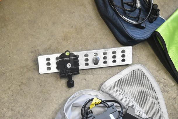 Lot of various items including a slotted metal bracket with a bubble level and black clamp, wires, and a nylon pouch.