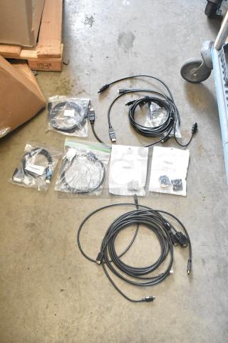 Lot of various cables in a poly bin, including HDMI and Ethernet, some in original packaging with visible labels. Suitable for electronics use.