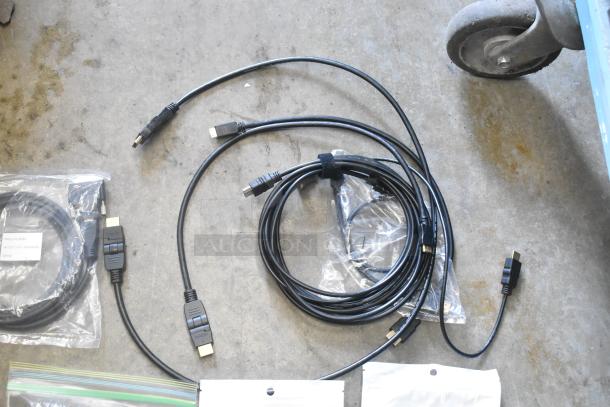 Lot of various cables including HDMI and USB, bundled in a poly bin. Mix of new and used condition, with original packaging visible.