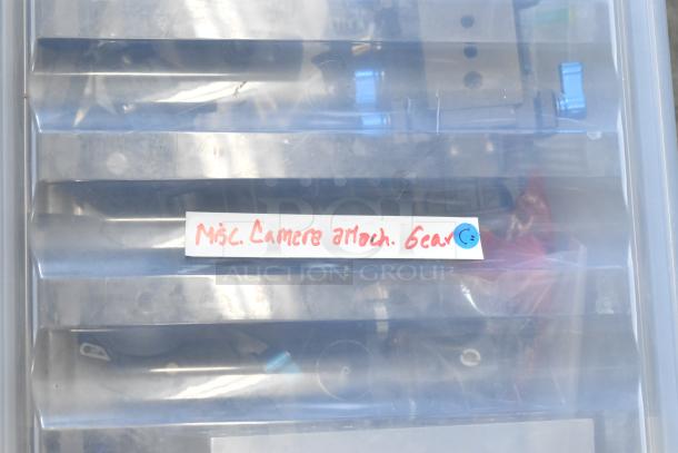 Poly bin containing assorted camera attachment gear, labeled "Misc. Camera Attach. Gear."