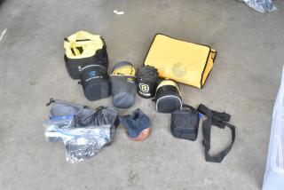 Assorted camera equipment lot including bags, pouches, straps, and cases, some branded "Lens Rentals" and "ET Base".