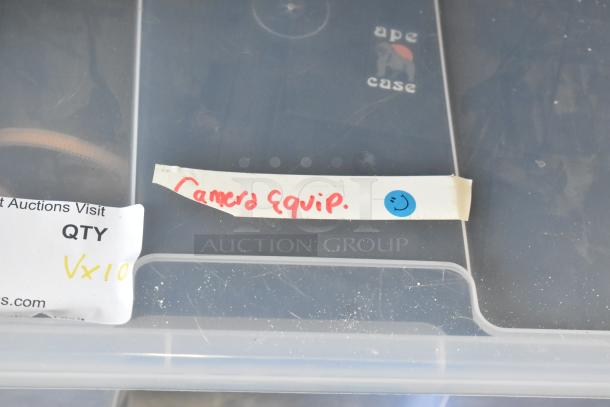Poly bin labeled "Camera Equip." and "ape case" contains camera gear and lenses. Marked QTY Vx10.