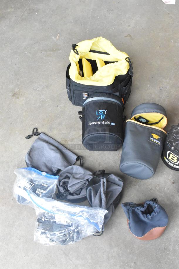 Lot of camera equipment in poly bin, including lens cases labeled "Jensrentals" and "Mountainsmith," and various accessories.