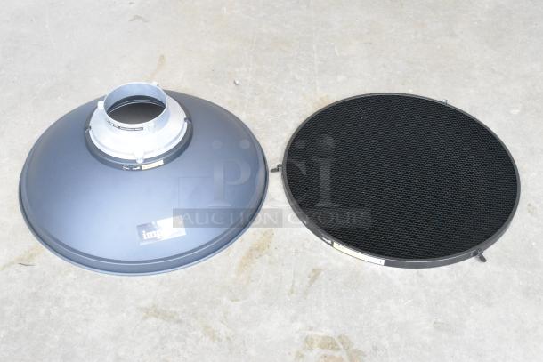 Lighting bonnet and plate, branded "Impact," feature a metallic build with a honeycomb grid. Good condition, slight wear.