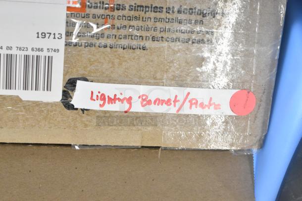 Cardboard box labeled "Lighting Bonnet/Plate" with red lettering and barcode; packaging intact.