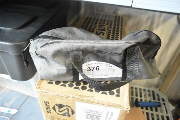 Soft gray bag containing a black unit, labeled with auction number 376; bag marked "Alur," indicating brand.