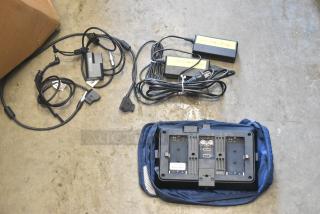 Small HD Monitor with cables, adapters, and battery chargers. Back view shows HDMI ports. Comes with a carrying case.