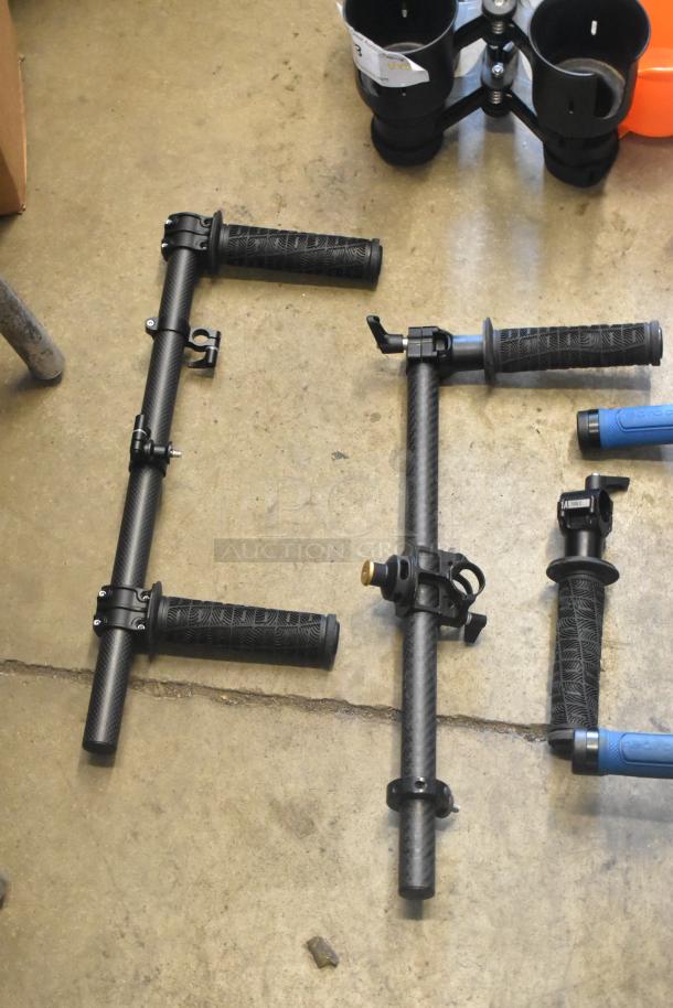 Lot of various frame pieces with carbon fiber texture and rubber grips, including connectors, on a concrete floor.