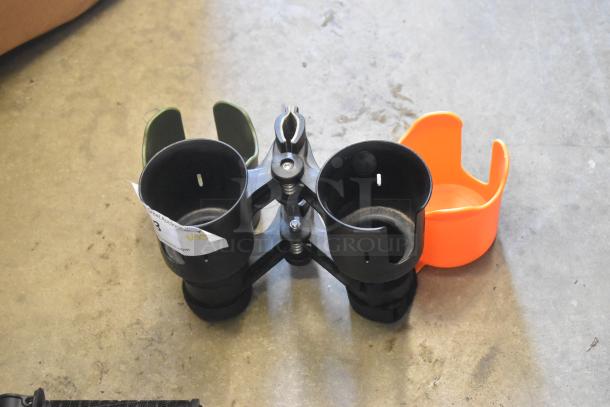 Lot of cup holders and frame pieces. Includes a green, orange, and two black holders, with auction tag visible.