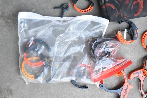 Lot of clamps in poly bucket, various brands and sizes, includes Cable Cuff and Mega Clamp, condition appears used.