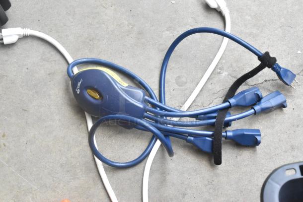 Lot of assorted cords and adapters with blue power splitter in poly bin, featuring multiple outlets and velcro strap.